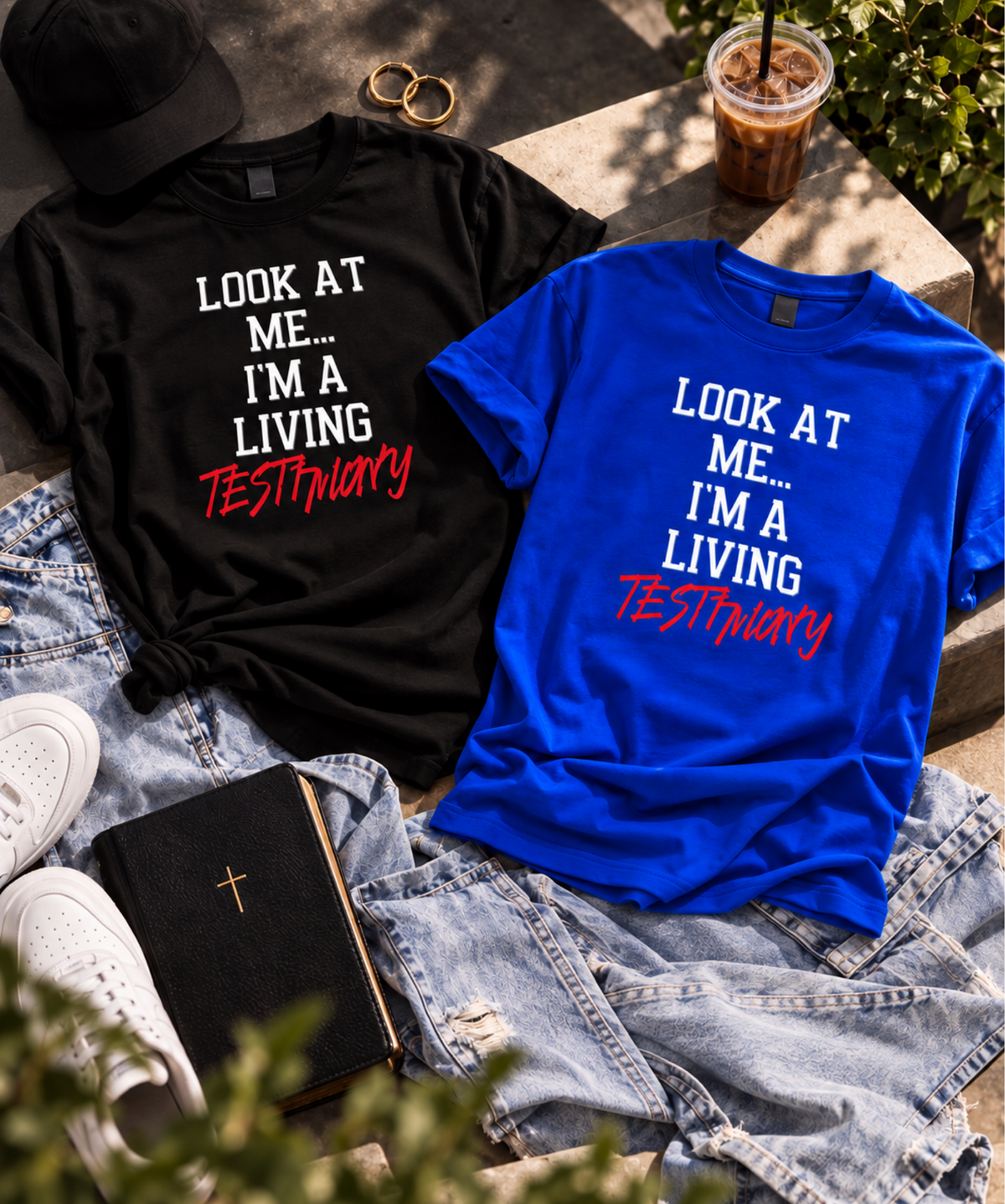 Two graphic T-shirts displayed in a styled flat-lay: one black and one bright blue, both with the text 'LOOK AT ME.