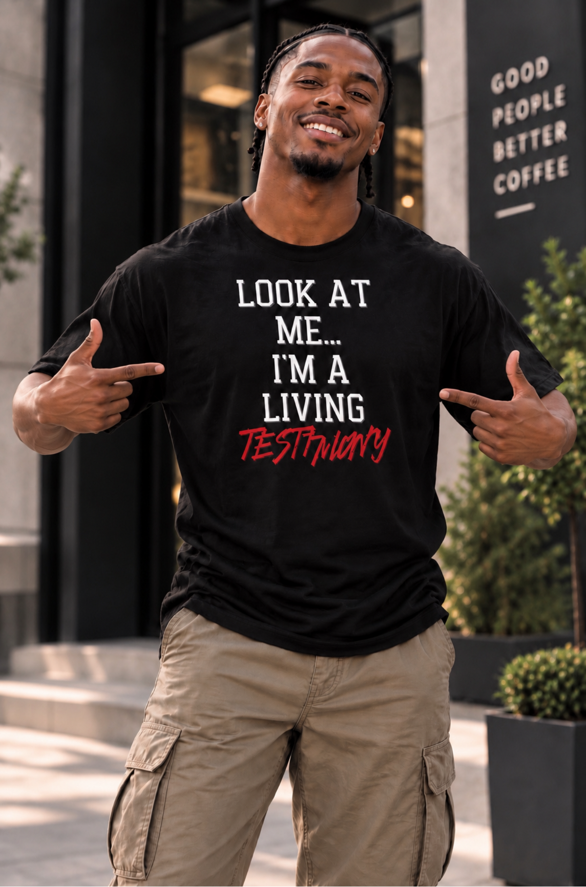 A man wearing a black graphic t-shirt with the text 'LOOK AT ME.
