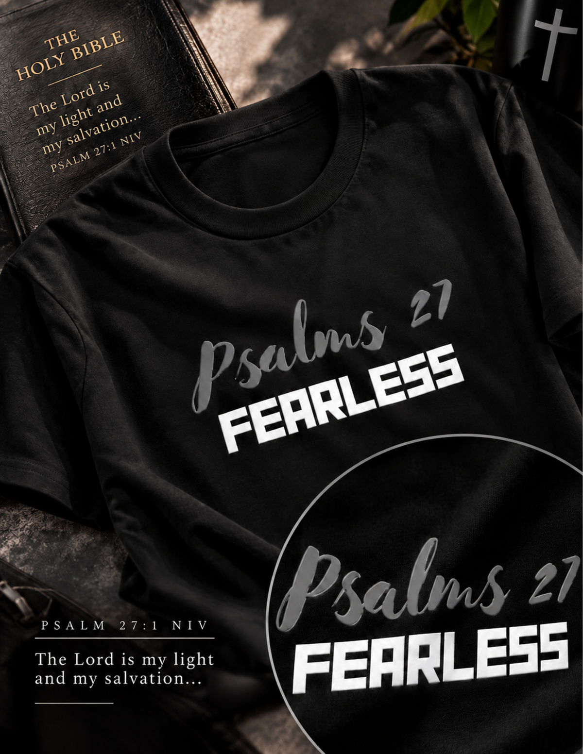 A black short-sleeve T-shirt laid flat on a dark textured surface, printed with the phrase 'Psalms 27 FEARLESS' in white and gray script. A large circular inset at the bottom right repeats the same print, and a Bible is partially visible in the upper left corner.